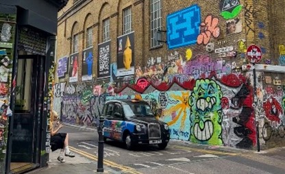 An image of street art and a taxi