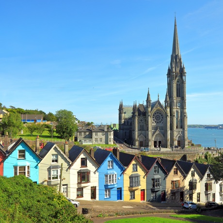Colourful homes in Cobh with Cathedral and sea in background