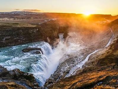 Sun rising over Icelandic landscape and waterfalls