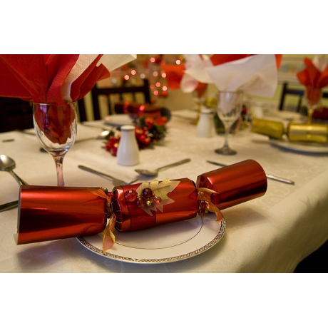 Red Christmas cracker sitting on a festive table