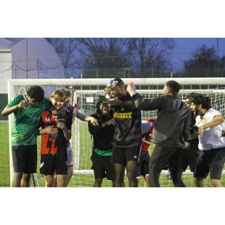 Football players celebrating with trophy