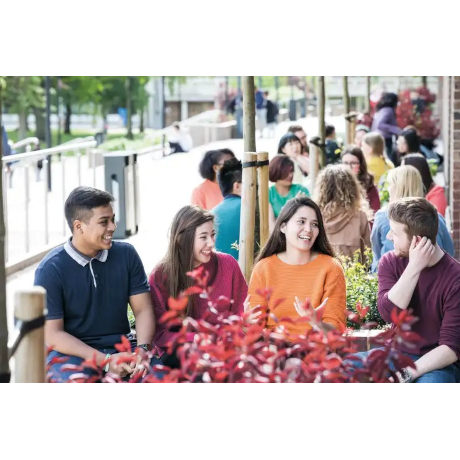 Students sitting at a table outside
