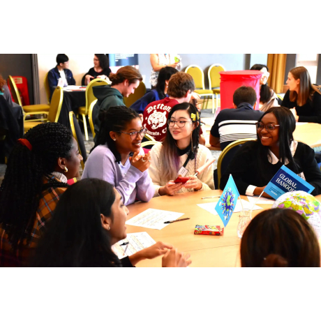 Group of students sitting around a table talking