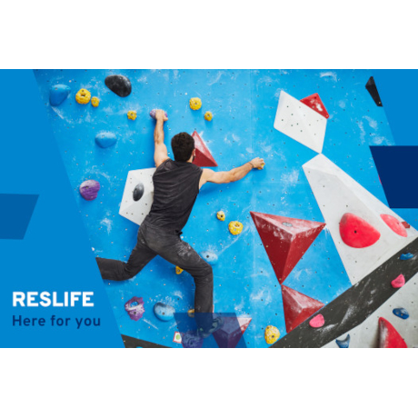 Man climbing a blue climbing wall