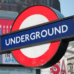 Street sign for London Underground - a white disc with a red outer circle, and a horizontal blue band reading underground.