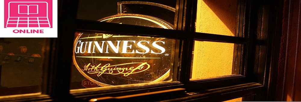 Nighttime photo of a Guinness sign through a window