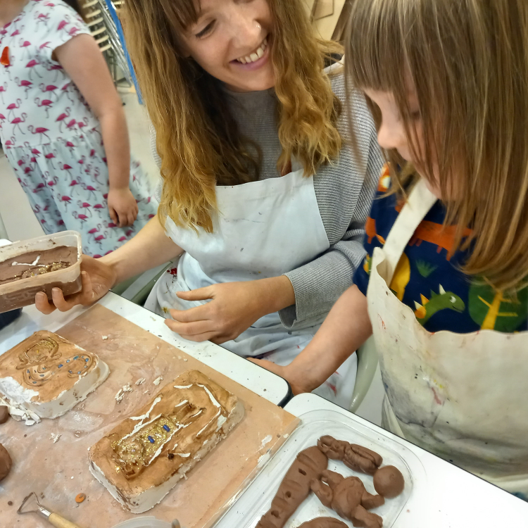 Participants taking part in a clay and plaster activity at Saturday Studio