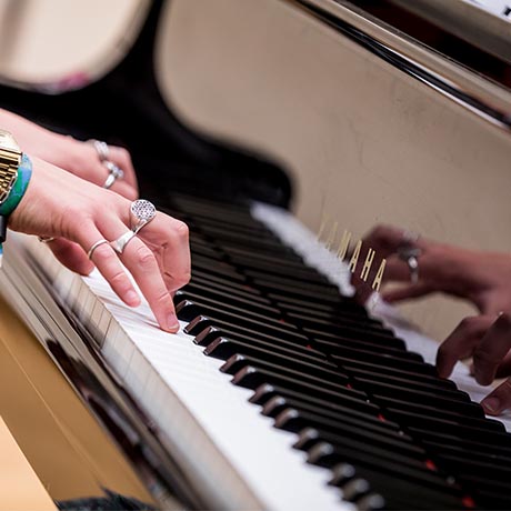 Woman's hands playing piano