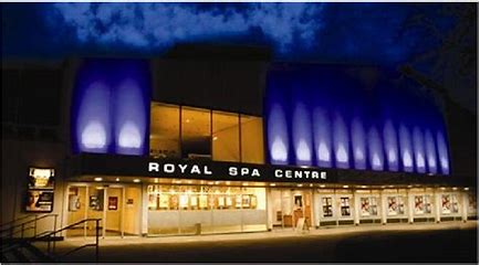 Front view of Royal Spa Centre at night with blue lights