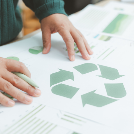 Hands resting on a sustainability poster