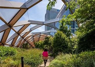 lady walking through indoor gardens with greenery