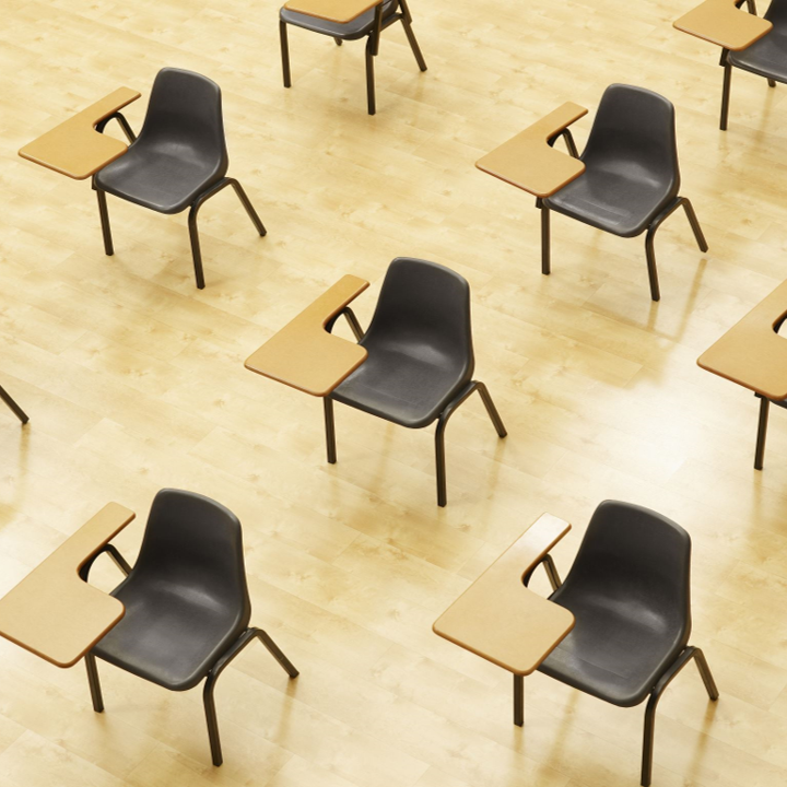 An exam room with black chairs