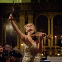 image of Harriet raising her bow at the end of a performance with candles in background
