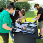 4 people writing on plates with safety visors on
