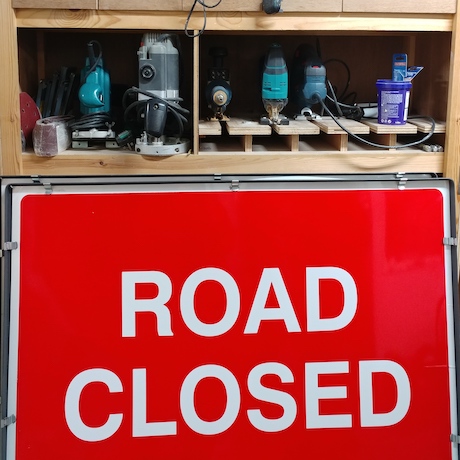 Road closed sign and shelf of tools (workshop)