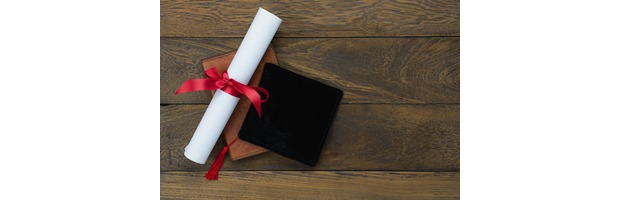 An exam scroll rolled up with a red bow