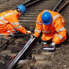 2 workmen inspecting rails