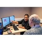 Image of a two people looking at a computer monitor