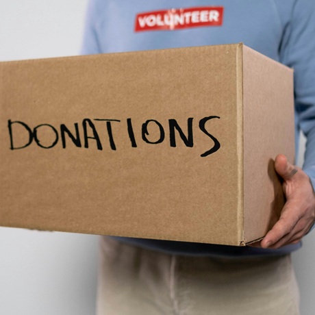 Donations box and charity worker