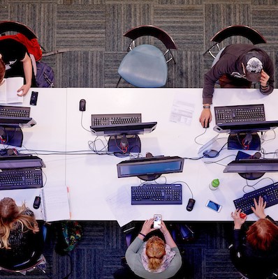 People sat at a Desk.