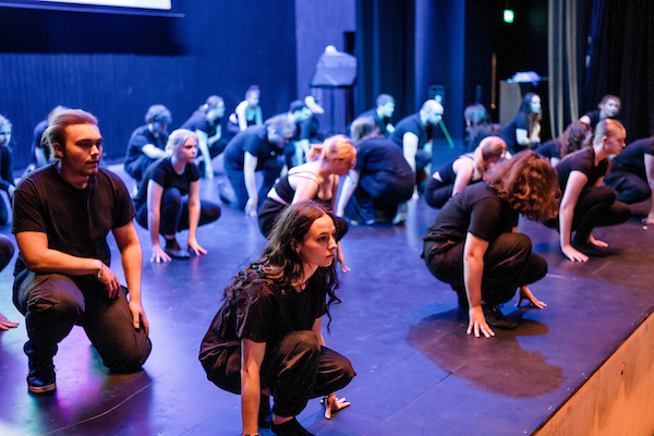 a group of theatre students kneeling down ready to spring up