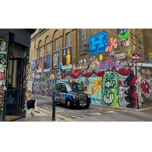 An image of street art and a taxi
