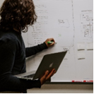 A picture of someone writing on a whiteboard